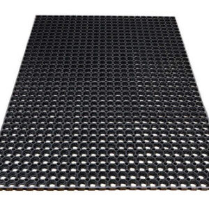 Black perforated mat with evenly spaced circular holes, designed for drainage and traction on floors.